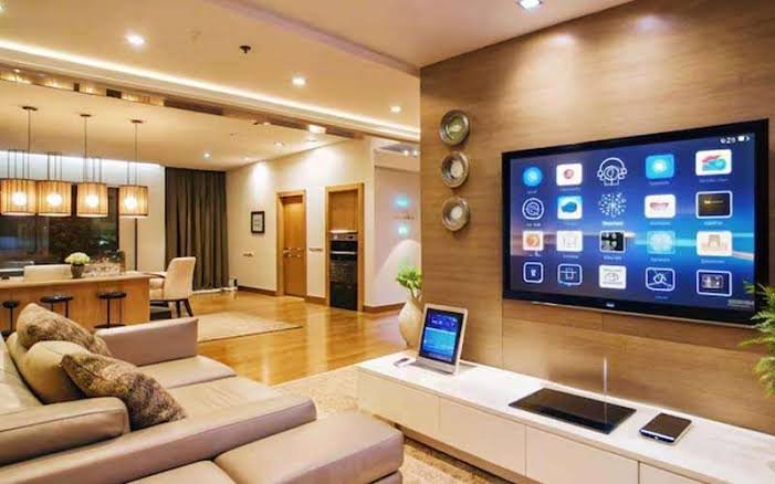 A modern, clean living room interior highlighting subtle, interconnected smart lighting and climate control devices.